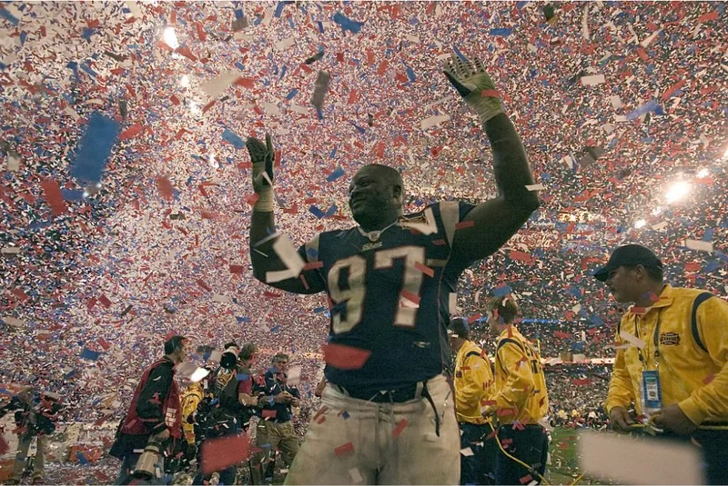 Jarvis Green, number 97, on the field amid confetti after a Super Bowl victory with the New England Patriots