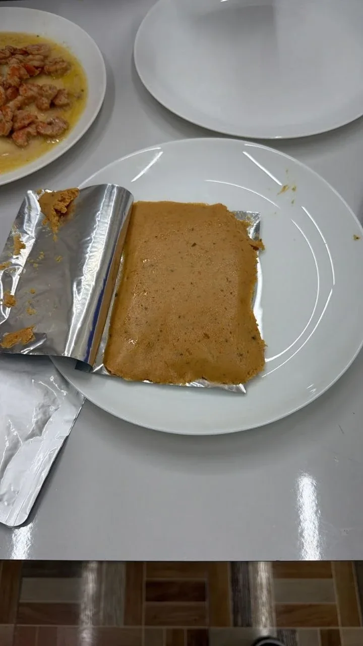 A block of Oceans 97 shrimp spread unwrapped on a plate